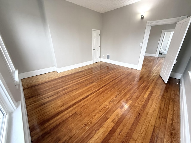 626 W 12th St, Covington, KY 41011 - empty room featuring hardwood / wood-style floors and a textured ceiling