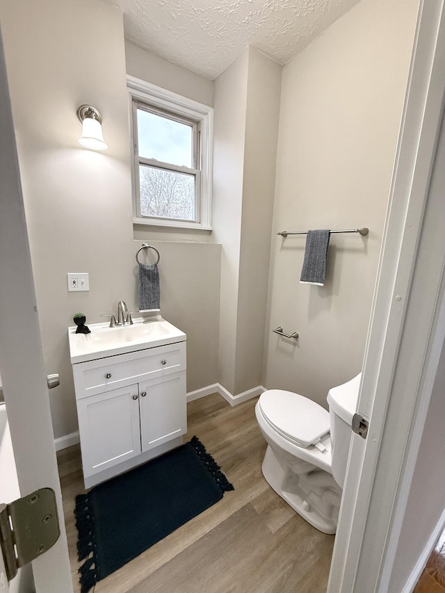 626 W 12th St, Covington, KY 41011 - bathroom featuring vanity, wood finished floors, and a textured ceiling