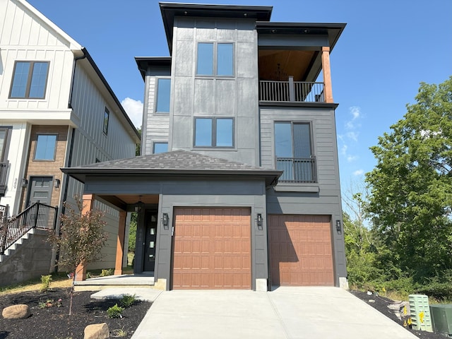 888 Belle Ridge Loop, Bellevue, KY 41073 - contemporary house with a balcony, concrete driveway, an attached garage, board and batten siding, and roof with shingles