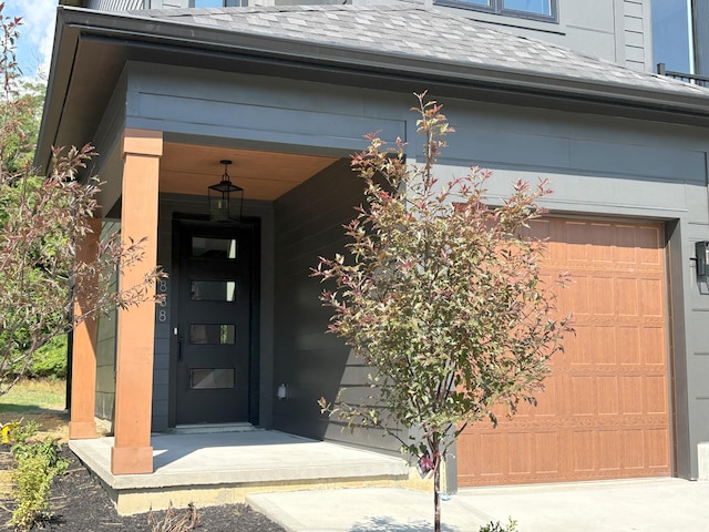 888 Belle Ridge Loop, Bellevue, KY 41073 - property entrance featuring a garage and a shingled roof