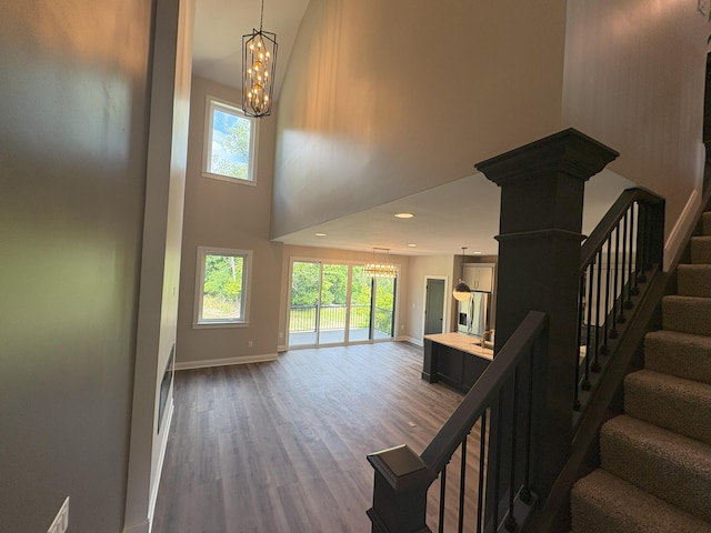 888 Belle Ridge Loop, Bellevue, KY 41073 - stairs with a chandelier, healthy amount of natural light, wood finished floors, a high ceiling, and recessed lighting