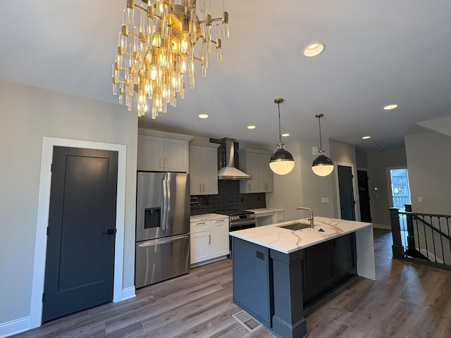 888 Belle Ridge Loop, Bellevue, KY 41073 - kitchen with stainless steel appliances, wall chimney range hood, tasteful backsplash, a center island with sink, and light stone counters