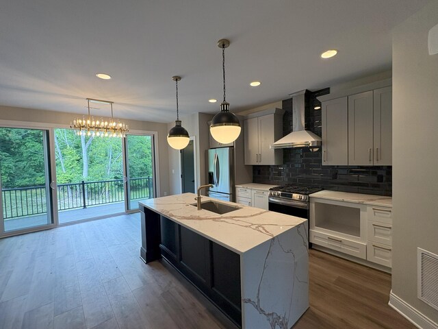 888 Belle Ridge Loop, Bellevue, KY 41073 - kitchen with wall chimney exhaust hood, appliances with stainless steel finishes, backsplash, a kitchen island with sink, and dark wood-type flooring