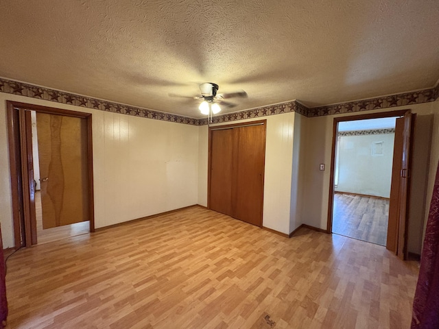 617 Woolery St, Falmouth, KY 41040 - unfurnished bedroom with light wood-style floors, a textured ceiling, and a ceiling fan