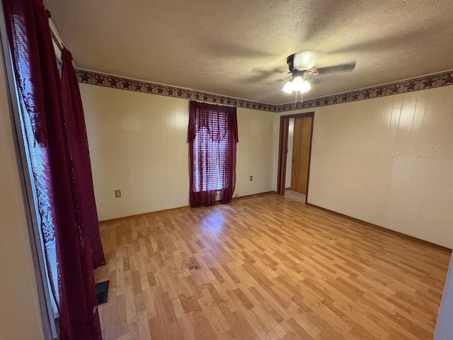 617 Woolery St, Falmouth, KY 41040 - empty room with light wood finished floors, a textured ceiling, and a ceiling fan
