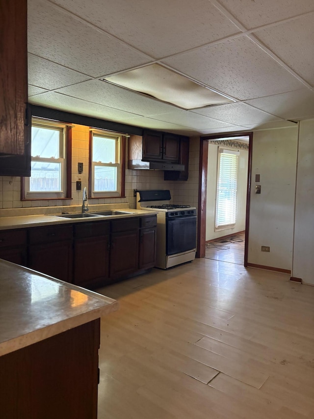 617 Woolery St, Falmouth, KY 41040 - kitchen featuring range with gas stovetop, a drop ceiling, light wood-type flooring, dark brown cabinets, and light countertops
