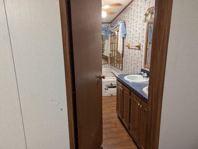 113 Lynn Ln, Falmouth, KY 41040 - bathroom featuring double vanity, wallpapered walls, wood finished floors, and a ceiling fan