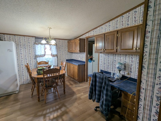 113 Lynn Ln, Falmouth, KY 41040 - dining space featuring wallpapered walls, crown molding, a textured ceiling, a chandelier, and wood finished floors