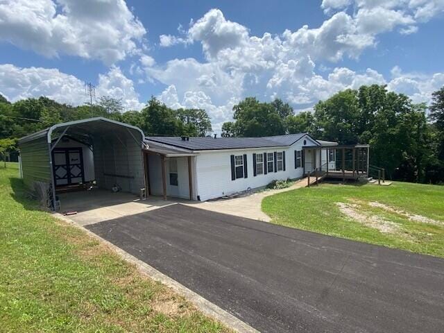 113 Lynn Ln, Falmouth, KY 41040 - view of front of property with a carport, a front lawn, driveway, and a shed
