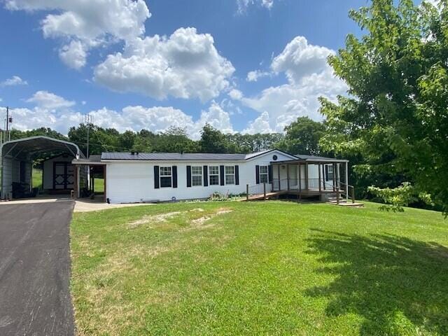 113 Lynn Ln, Falmouth, KY 41040 - manufactured / mobile home with a carport, a front yard, asphalt driveway, and a porch