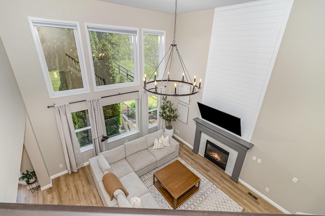1312 Deer Hollow Ct, Hebron, KY 41048 - living room with wood finished floors, a chandelier, and a glass covered fireplace