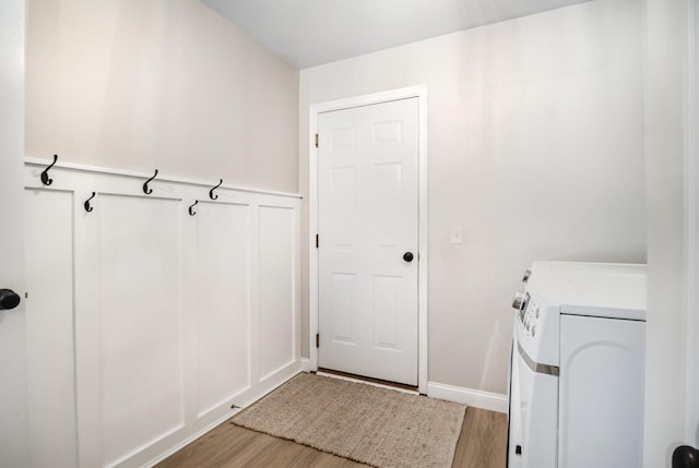 1312 Deer Hollow Ct, Hebron, KY 41048 - laundry room with washing machine and dryer, light wood-type flooring, wainscoting, and a decorative wall