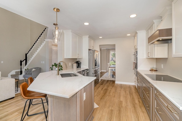 1312 Deer Hollow Ct, Hebron, KY 41048 - kitchen featuring light wood-style floors, white cabinets, a kitchen bar, a peninsula, and recessed lighting