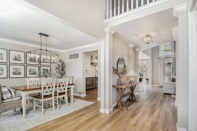 1312 Deer Hollow Ct, Hebron, KY 41048 - dining room featuring a chandelier, wood finished floors, a high ceiling, and ornamental molding
