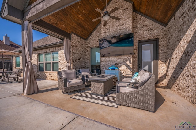 view of patio / terrace featuring ceiling fan and an outdoor living space with a fire pit