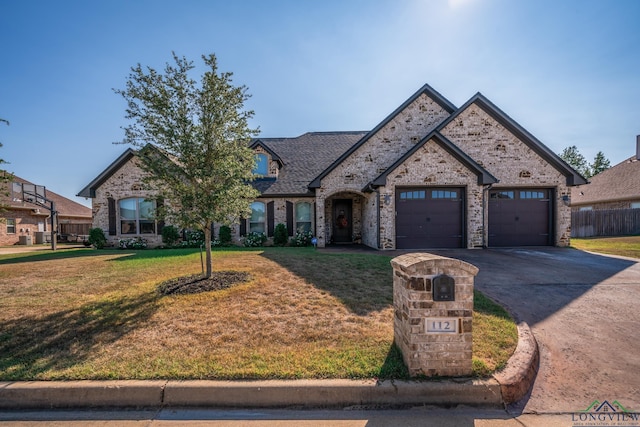 view of front of house with a front lawn and a garage