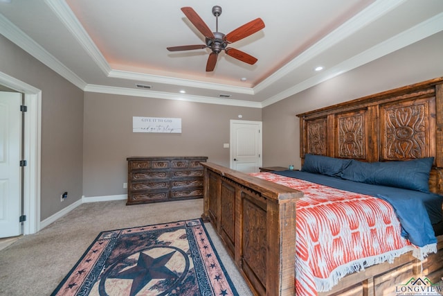 bedroom featuring light carpet, a tray ceiling, ceiling fan, and crown molding