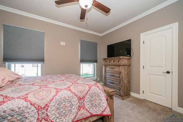 carpeted bedroom with ceiling fan and ornamental molding