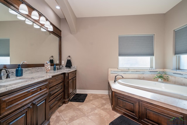 bathroom featuring tile patterned floors, a washtub, and vanity