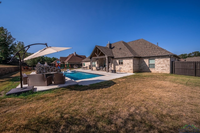 view of pool with a yard and a patio