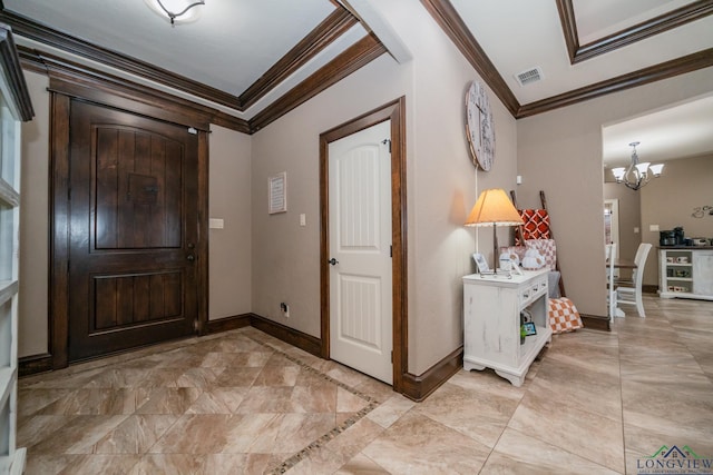 foyer featuring a chandelier and ornamental molding