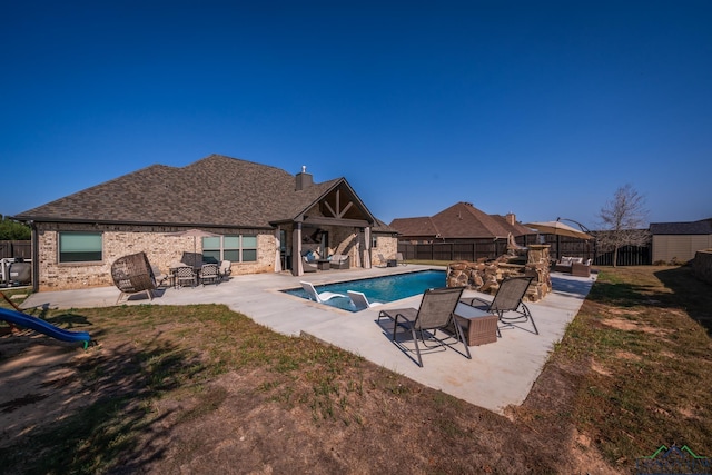 view of swimming pool with a patio area