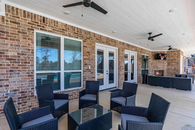 view of patio with french doors and an outdoor living space with a fireplace