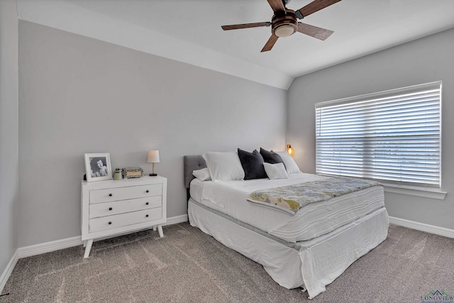 bedroom with lofted ceiling, carpet flooring, baseboards, and ceiling fan