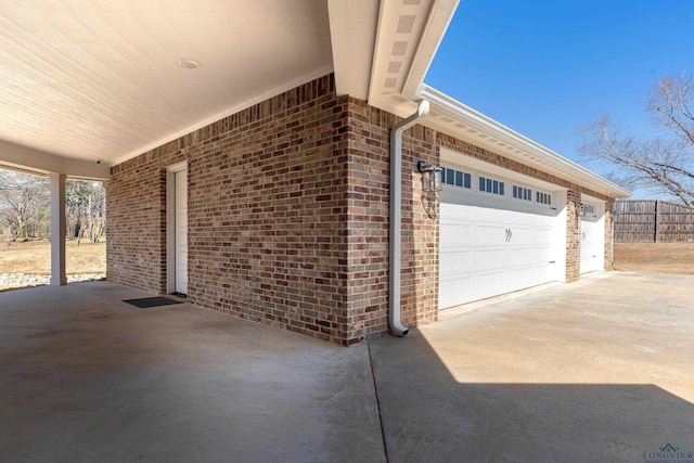 exterior space featuring driveway and fence