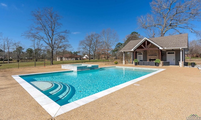 view of swimming pool featuring an outdoor structure, fence, a lawn, and a pool with connected hot tub