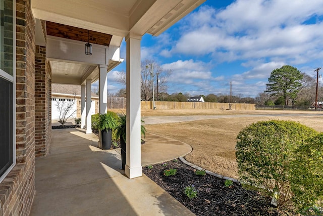 view of patio featuring fence