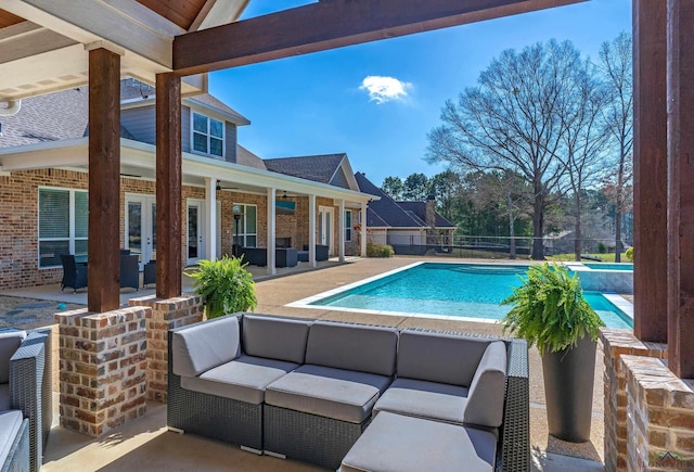 view of pool with a fenced in pool, fence, an outdoor hangout area, a patio, and a ceiling fan