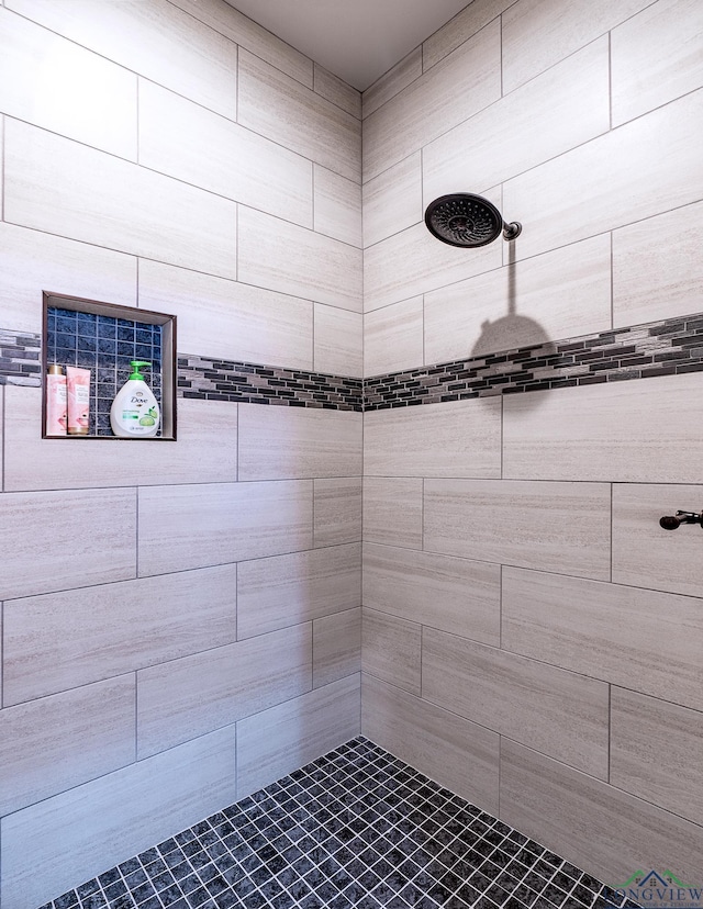 bathroom with a tile shower