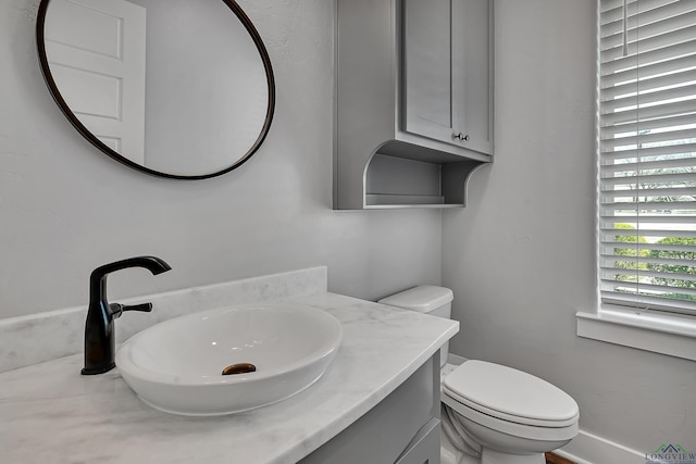 half bath with vanity and toilet