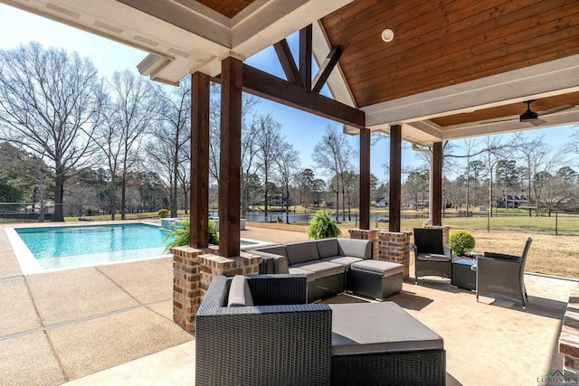 view of patio featuring a fenced in pool, an outdoor hangout area, a ceiling fan, and fence