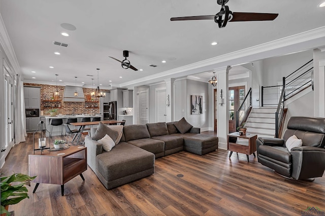 living area featuring dark wood-type flooring, a ceiling fan, and visible vents