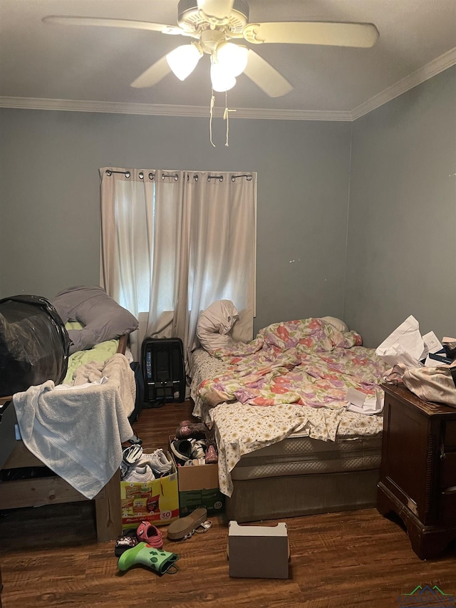 bedroom featuring ceiling fan, dark hardwood / wood-style floors, and ornamental molding