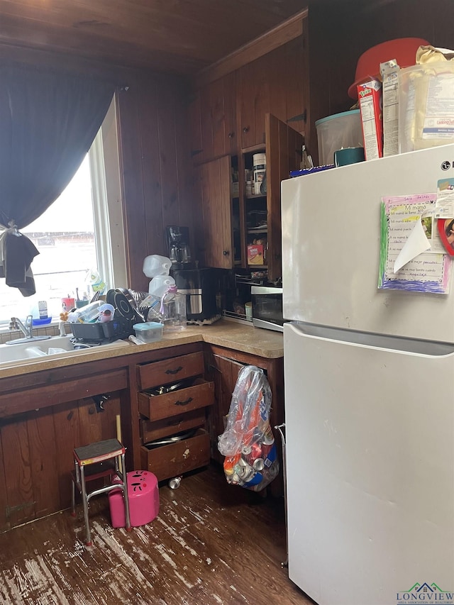 kitchen featuring white fridge, dark hardwood / wood-style flooring, and sink