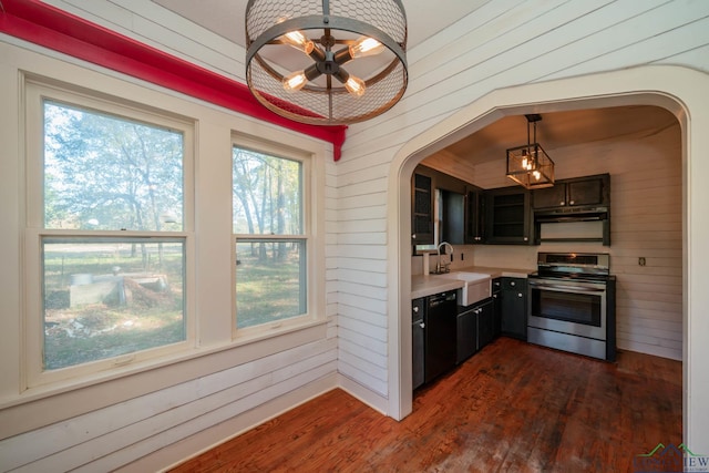 kitchen featuring ceiling fan, stainless steel range, sink, black dishwasher, and decorative light fixtures