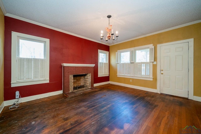 unfurnished living room with a wealth of natural light, a fireplace, hardwood / wood-style floors, and ornamental molding