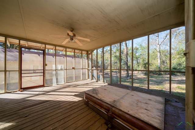 unfurnished sunroom featuring ceiling fan