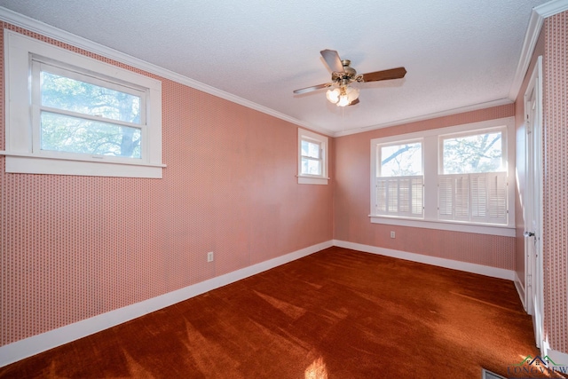 carpeted spare room with crown molding, ceiling fan, and a textured ceiling