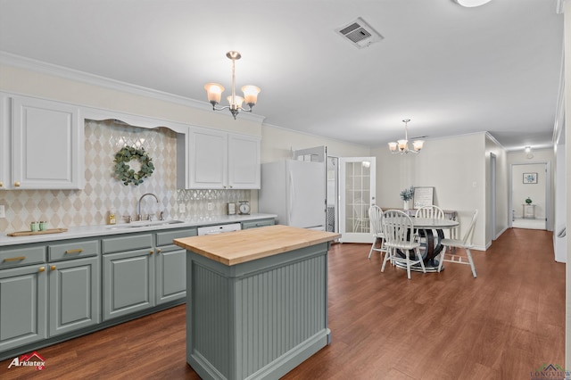 210 Southview Dr, Henderson, TX 75654 - kitchen with a chandelier, a sink, white appliances, butcher block countertops, and crown molding