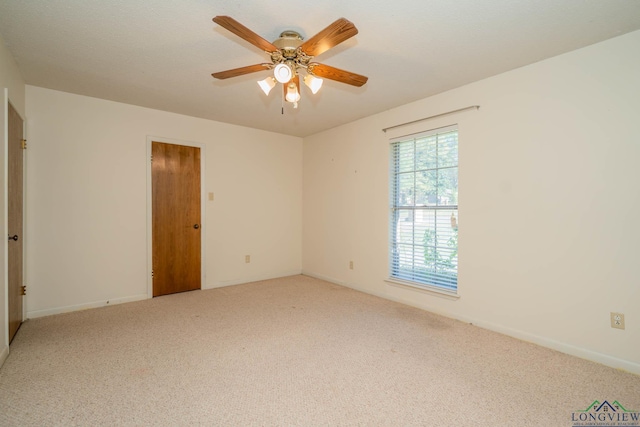 spare room featuring carpet and ceiling fan