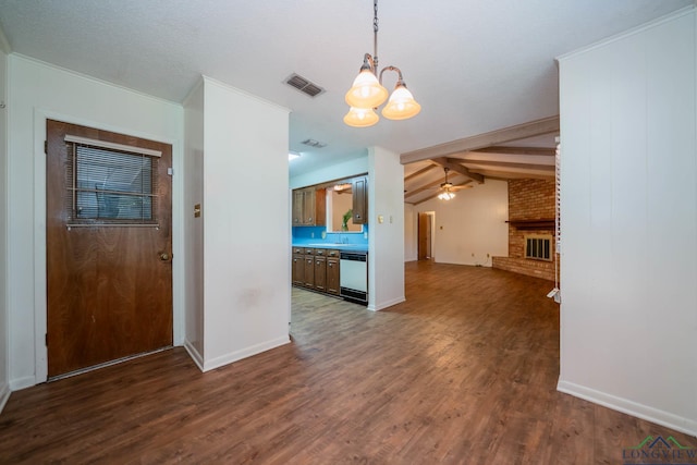 unfurnished dining area featuring lofted ceiling with beams, dark hardwood / wood-style floors, a fireplace, and ceiling fan with notable chandelier