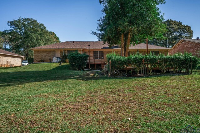 rear view of house featuring a yard