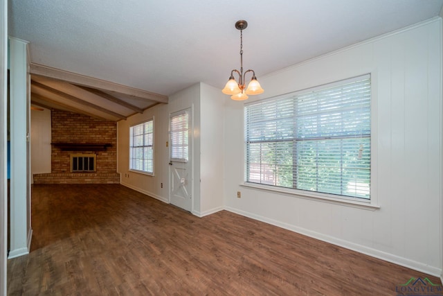 unfurnished living room with a chandelier, vaulted ceiling with beams, a brick fireplace, and dark wood-type flooring