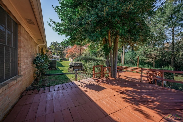 wooden deck with a lawn