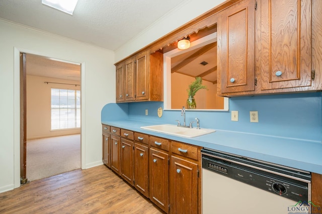 kitchen featuring a textured ceiling, dishwasher, light hardwood / wood-style floors, and sink