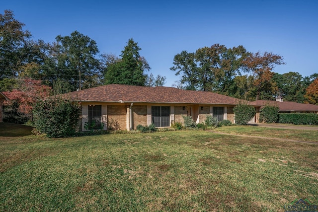 ranch-style home with a front lawn